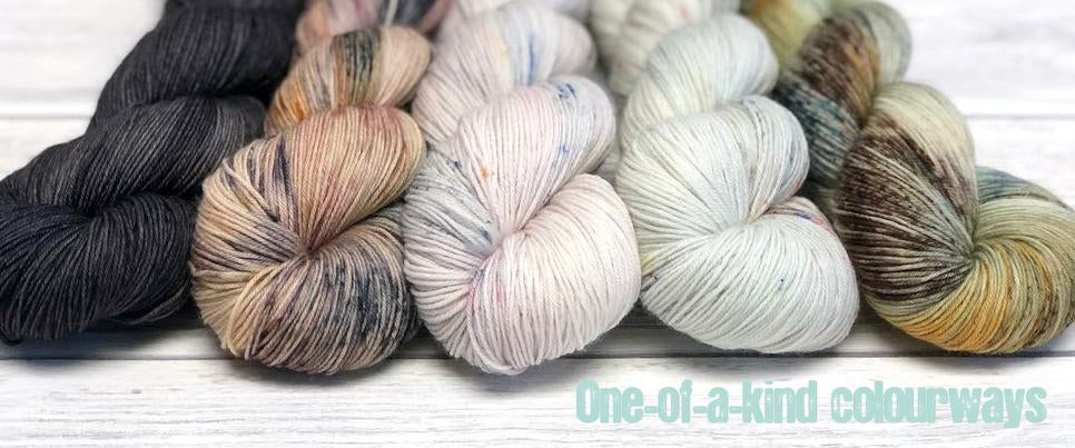Skeins of yarn in various shades with text One-of-a-kind colourways
